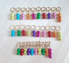 several keychains with numbers and letters on them sitting on a white table next to each other