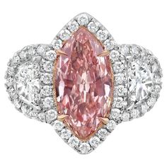 This exquisite pink diamond engagement ring features a striking 2.03-carat fancy pink-brown marquise cut diamond at its heart, offering a unique blend of romance and elegance. With SI2 clarity, this GIA certified diamond shines with character and charm, framed by 0.63 carats of E-F color epaulette side diamonds and 0.62 carats of E-F round diamonds that enhance its brilliance. Handcrafted in NYC, the ring is set in a luxurious combination of platinum and 18k gold, making it a true work of art. P Pink Diamond Cut Diamond Ring, Luxury Pink Diamond Ring With Brilliant Cut, Luxury Pink Brilliant Cut Diamond Ring, Luxury Pink Gia Certified Diamond Ring, Pink Marquise Center Stone Jewelry, Pink Marquise Ring With Center Stone, Pink Marquise Rings With Center Stone, Luxury Pink Diamond Ring With Center Stone, Pink Marquise Diamond Ring For Anniversary