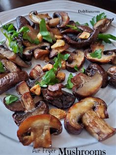 mushrooms on a white plate with parsley