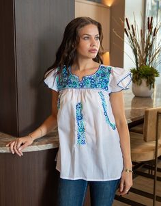 This hand embroidered Mexican top, was made in Santo Tomas de Jalieza, Oaxaca, Mexico. Handmade by artisan, Katia, this embroidered, tunic style top was hand embroidered over a period of two months.  A classic fit, styled with ruffled sleeves, it is made in a breathable, lightweight poplin fabric and delicately embroidered with silk thread. 🦋Handmade/Artisanal Features:  Handcrafted in Oaxaca, Mexico, using a soft and breathable poplin fabric and silk thread embroidery. This is a classic tunic Artisan Embroidered Summer Top, Artisan Embroidered Tops For Summer, Bohemian Peasant Top With Multicolor Embroidered Neckline, Bohemian Embroidered Short Sleeve Peasant Top, Bohemian Peasant Top With Embroidered Hem, Bohemian Short Sleeve Peasant Top With Embroidered Hem, Bohemian Peasant Top With Embroidered Hem And Short Sleeves, Folk Peasant Top With Multicolor Embroidered Neckline, Peasant Tops With Multicolor Embroidered Sleeves