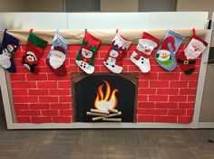 a fire place decorated with stockings and snowmen