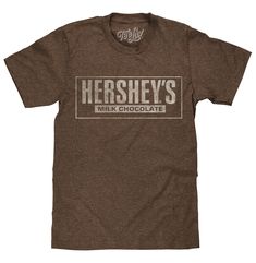 PRICES MAY VARY. SWEETEN UP YOUR WARDROBE: Show off your love for America's favorite chocolate with the classic Hershey's Milk Chocolate logo - distressed and printed on the softest brown heather tee we could find. EASY CARE TEES: This Hershey's design is licensed and screen-printed on a soft, high-quality poly-cotton t-shirt that goes from the washing machine to the dryer without losing shape, shrinking or fading. Graphic is intentionally distressed for a worn, vintage look. NO FUSS SIZING: Tee Hershey Logo, Chocolate Shirt, American Chocolate, Chocolate Logo, Retro Candy, Mens Fade, Hershey Chocolate, Brown Tshirt, Retro Tee