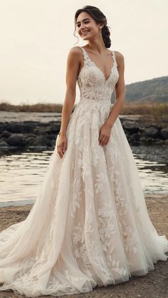 a woman in a wedding dress standing on the beach