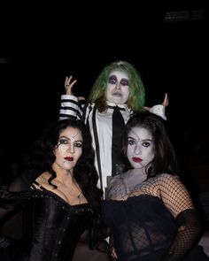 three people dressed up in costumes posing for the camera