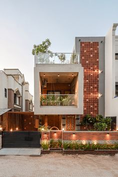 an apartment building with plants growing on the balconies