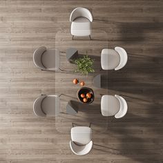 an overhead view of a dining room table with chairs and fruit in a bowl on it