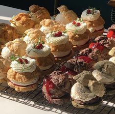 many different types of pastries on a cooling rack