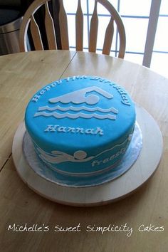 a blue cake sitting on top of a wooden table