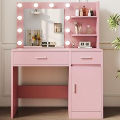 a pink vanity with lights on it next to a potted plant and a mirror