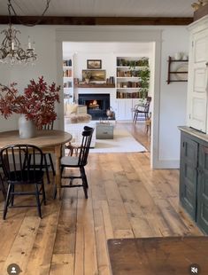 a dining room with wooden floors and white walls