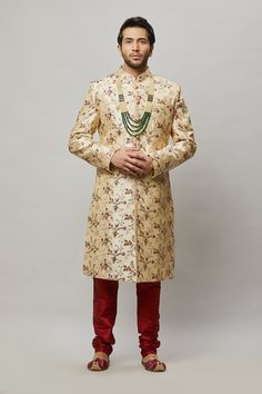 Men's floral embroidered sherwani with shades of Red, Blush & Sage in the flowers and petal Comes with a Red churidar Crafted with a collar neckline, full sleeves, and front button closure. Occasion: Can be worn to events like Sangeet, & Wedding WASH CARE INSTRUCTIONS - Please Dry clean only when it is applicable. Slight color variation is possible due to digital photography. Necklace not included Bollywood Style Sherwani With Floral Embroidery For Festivals, Bollywood Style Ceremonial Sherwani With Floral Embroidery, Formal Sherwani With Floral Embroidery For Diwali, Bollywood Style Sherwani With Floral Embroidery For Ceremonial Occasions, Elegant Fitted Churidar For Traditional Ceremonies, Fitted Sherwani For Traditional Ceremonies And Festivals, Fitted Sherwani For Festivals And Traditional Ceremonies, Bollywood Sherwani With Floral Embroidery For Formal Occasions, Fitted Bollywood Style Sherwani For Traditional Ceremonies