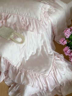 a bed with pink flowers and a white pillow