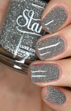 Overview: • Silver micro reflective glitter in a clear base • Use alone in 3 coats or sponge on for full opacity • Can also be used as a topper over other colors • Dries textured, use top coat for a smooth finish Description: Imagine a world where your nails sparkle like diamonds in the night sky, where every move you make sends glimmers of light dancing across your fingers. This is the world of Crystal, a dazzling silver reflective nail polish that will transport you to a realm of glamour and e Nails Sparkle Glitter, Silver Nails Glitter, Christmas Sparkle Nails, Silver Reflective Glitter Nails, Gray Sparkle Nails, Light Gray Sparkle Nails, Silver Sparkly Nails, Dark Gray Sparkle Nails, Silver Glitter Nail Polish