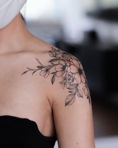 a woman's shoulder with flowers on it