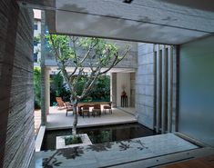 an outdoor living area with a tree and water feature