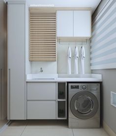 a washer and dryer in a room with striped wallpaper on the walls