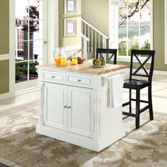 a white kitchen island sitting in the middle of a room