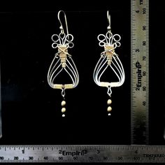 "Sterling Silver and 14K gold filled wire combine with wire wrapping to make these Egyptian style earrings. Lightweight on your ears but sturdy. Handmade. Average time to make these is 1-2 days. The dangling beads are also 14K gold filled and the earrings hang 2-3/4\" from the finest sterling earwires that come with rubber earnuts. Interested in a matching bracelet? see this lisitng: http://www.etsy.com/listing/77246374/egyptian-bracelet-wirewrapped-sterling I also make a matching pendant. Conta Egyptian Earrings, Egyptian Bracelet, Egyptian Style, Matching Bracelet, Matching Bracelets, Style Earrings, Wire Wrapping, Gold Filled, Two Tone