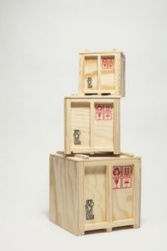 three wooden boxes stacked on top of each other