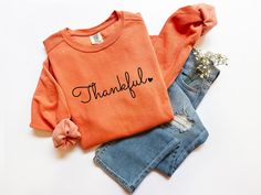 Are you looking a Thankful Sweatshirt? We've got you! ABOUT OUR Womens Thanksgiving Comfort Colors® shirt *80% ring-spun cotton, 20% polyester *Medium-heavy fabric  *Relaxed fit *Sewn in twill label *OEKO-TEX certified low-impact dyes HOW TO ORDER your Thanksgiving Family Shirt 1. Check our photos for sizing and color options.  2. Choose your quantity. Feel free to add as many shirts as you wish!  3. Select your size and color from the drop-down menus.  4. Click "ADD TO CART" to add the shirt to your virtual cart.  5. Click "PROCEED TO CHECKOUT" to purchase your shirt.  6. Your shirt is now off to production! We will process your order and your shirt will be ready for shipment in 1-4 days!  SIZE ▸ Take a look at the photos to see a specific sizing chart for this t-shirt style ▸ Please note Thankful Sweatshirt, Cowl Neck Sweatshirt, Target Clothes, Thanksgiving Shirts, Fall Sweatshirt, Embroidery Ideas, Halloween Sweatshirt, Workout Sweatshirt, Country Girl