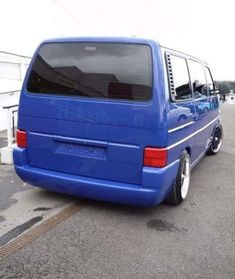 a blue van is parked on the street