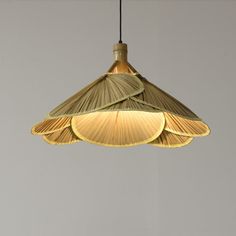 a light that is hanging from the ceiling in front of a gray wall and floor