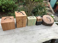 four wooden boxes sitting on top of a bench