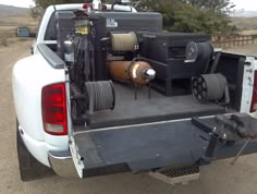 the back end of a white truck filled with equipment