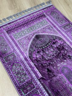 a purple rug with an intricate design on it