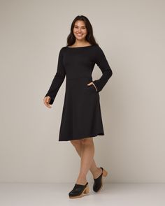 Effortlessly elegant—this sleek and structured dress features subtle details and a modern fit. - Easy boat neckline- Subtle long bell sleeves- Flattering waist seam- Full skirt- Hits below knee on most- Dress version of the Iris Bell Sleeve Top Sizing Tip: The Marnie is a fit & flare. Slim around the chest and waist, with a roomy, flared bottom. Easy Boat, Black Bell Sleeve Dress, Merino Wool Dress, Structured Dress, Tunic Leggings, Skirt Jumpsuit, Bell Sleeve Dress, Boat Neckline, Wool Dress