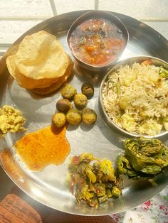 a silver plate topped with different types of food