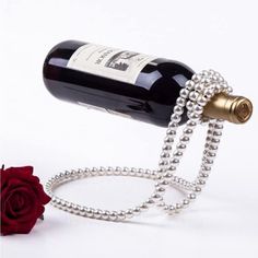 a wine bottle that has been chained to a chain with a rose in the background