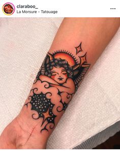 a woman's arm with an angel tattoo on the left side of her hand