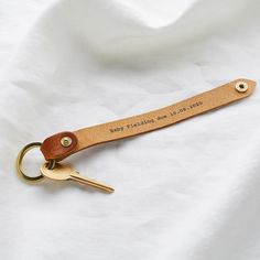 a leather keychain with a personalized message on it