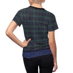 a woman wearing a green and black plaid shirt with her back turned to the camera