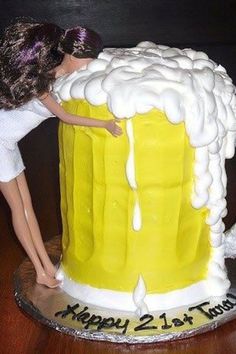 there is a cake that has a doll on it and a woman leaning over the top