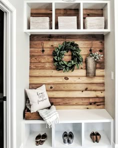 the entryway is decorated with wood planks and white shelving, including a wreath