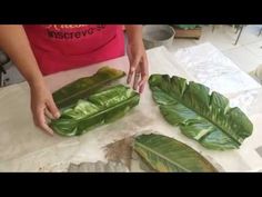 someone is cutting up some leaves on a table