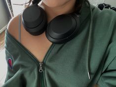 a woman with headphones on her neck