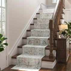 a staircase with carpeted steps leading up to the second floor