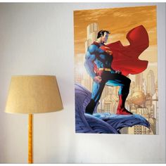 a superman poster hanging on the wall next to a lampshade and lamp shade