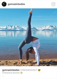 a woman doing yoga on the beach with her hands in the air and one leg up