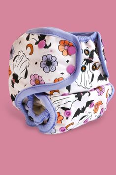 a close up of a cloth diaper on a pink background with flowers and cats