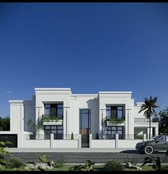 a car is parked in front of a two story white building with balconies