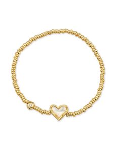 An easy addition to any wrist stack, meet the Ari Heart Gold Stretch Bracelet. Our iconic sweet heart shape meets the versatile stretch bracelet style, perfect for adding a casual but cute pop of color to your look. The best part? It’s designed to fit any wrist. Size: 6.5" unstretched circumference with 0.5"L x 0.3"W station Gold Stretch Bracelet, Wrist Stack, Wrist Stacks, Gold Girl, School Jewelry, Bracelet Style, Classy Jewelry