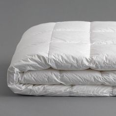 three white pillows stacked on top of each other