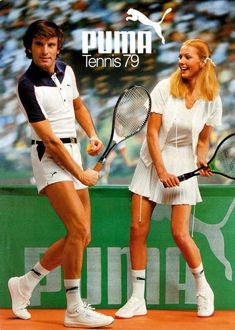 a man and woman holding tennis racquets on top of a tennis court