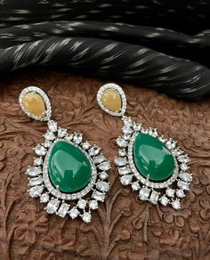 "Discover our stunning silver diamond earrings adorned with multicolored stones, including mustard yellow, emerald green, and cubic zirconia. Perfect for Indian cocktail parties and special occasions, these elegant earrings blend vibrant colors with timeless style, making them a must-have in your Pakistani jewelry collection. Earrings are Approximately 3 Inches Long and 1.2 Inches Wide  "Our products are meticulously handcrafted, ensuring each piece is unique. Due to the manual craftsmanship, you may notice slight irregularities, which are natural and do not compromise the quality of the jewelry. Green Jeweled Fusion Earrings, Green Diamond Earrings For Parties, Green Diamond Drop Earrings For Bridal, Green Diamond Drop Bridal Earrings, Green Fusion Earrings For Celebration, Green Fusion Style Earrings For Celebration, Green Diamond Party Earrings, Multicolor Diamond Round Earrings, Multicolor Round Diamond Earrings