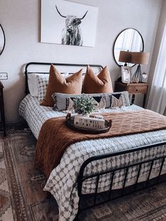 a bed with pillows and blankets on top of it