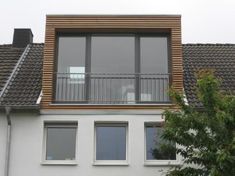 an apartment building with two balconies on the second floor